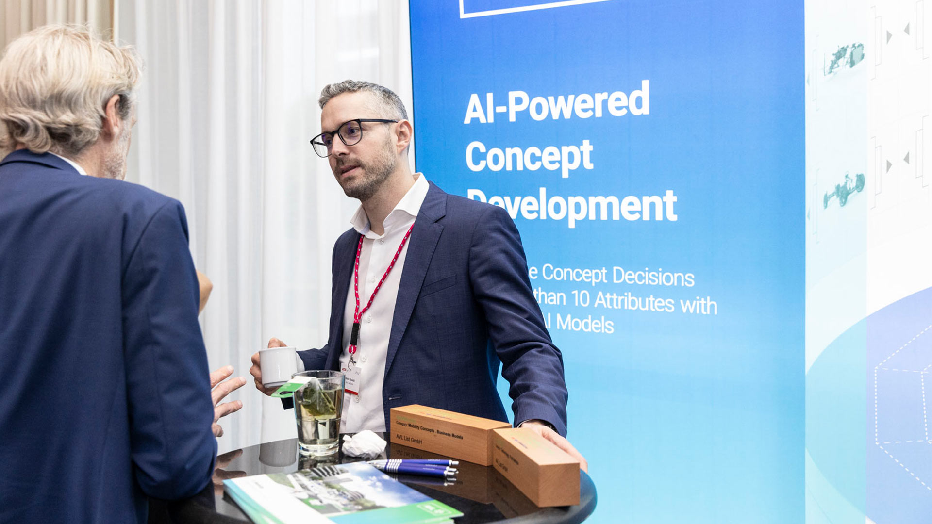 Two gentlemen in conversation at the AVL exhibition stand