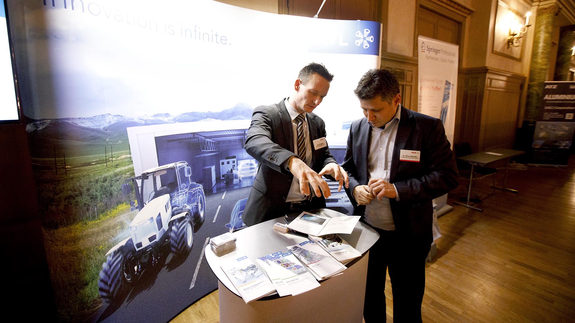Two gentlemen in conversation at the AVL exhibition stand.