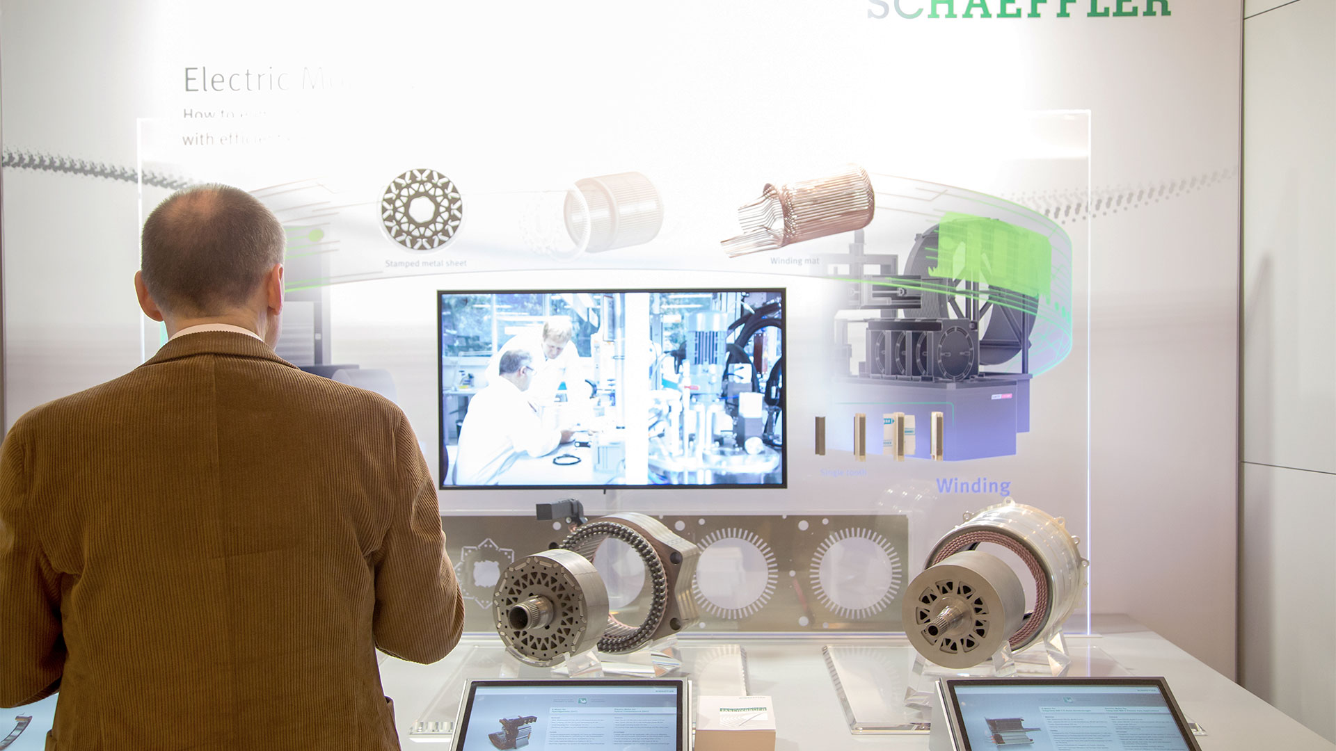 A gentlemen looks at an exhibit in the exhibition area.