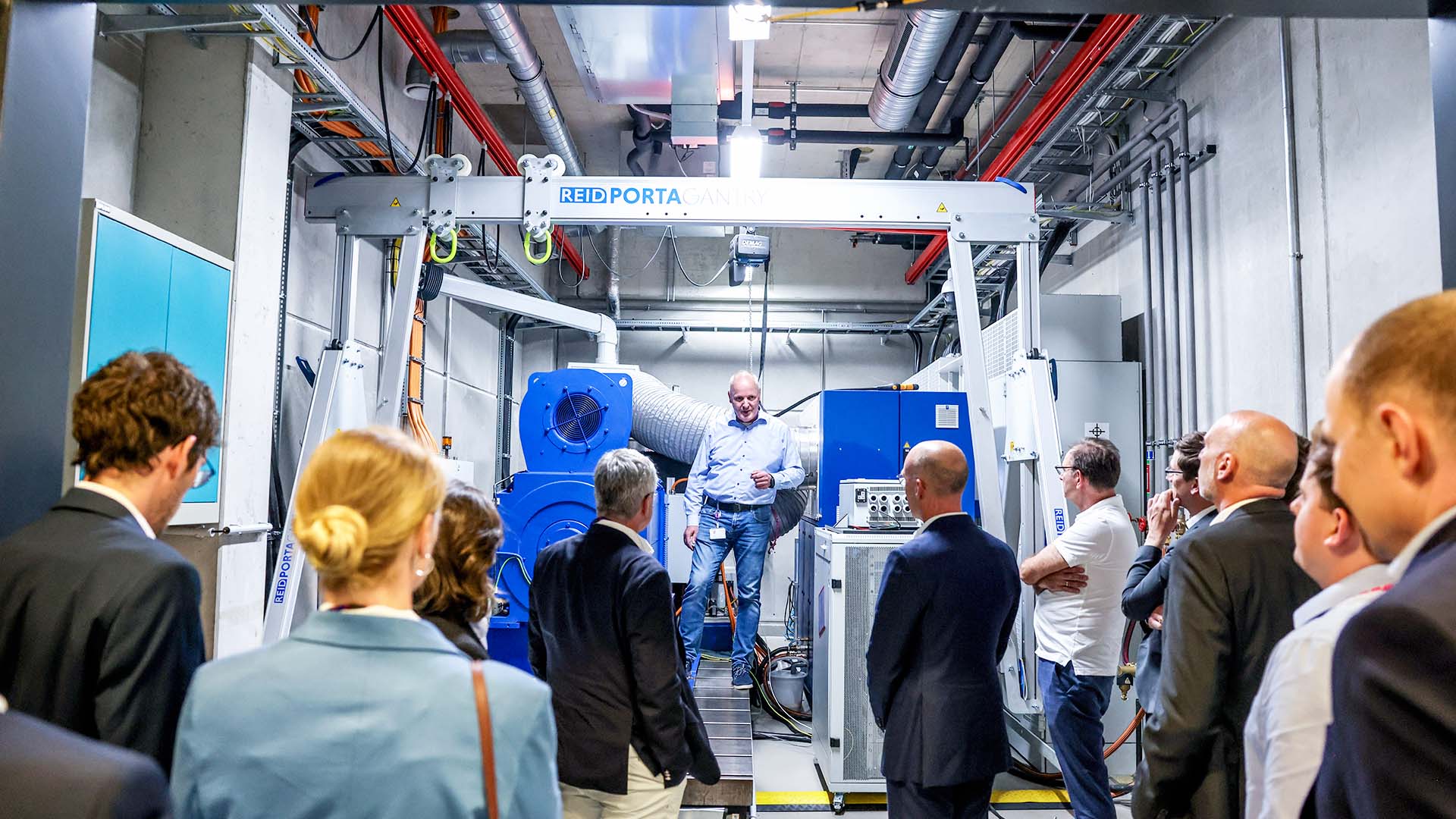 Participants listen to the explanations of the group leader during a tour of the company.