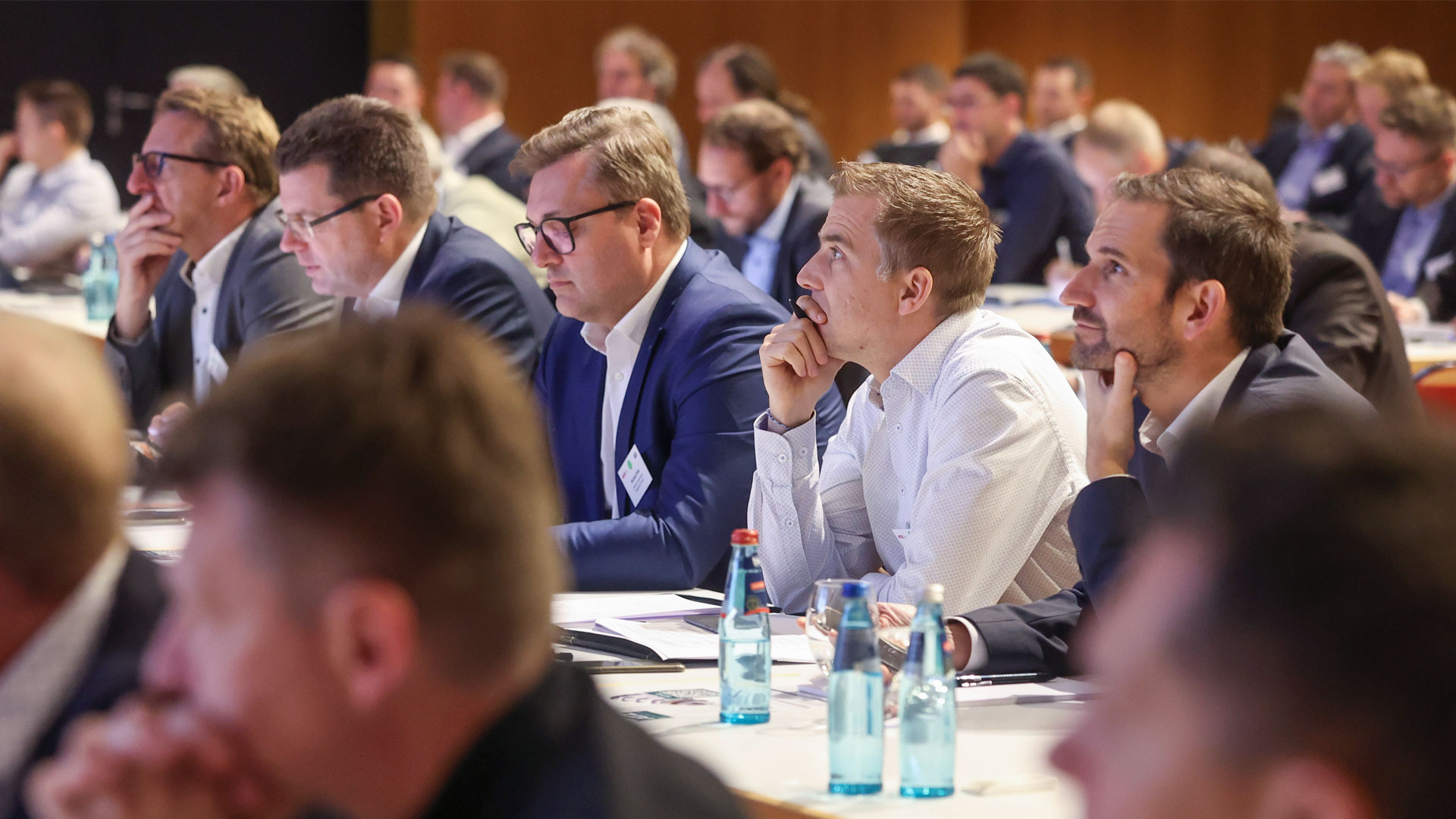 Conference participants in the plenum follow the presentation
