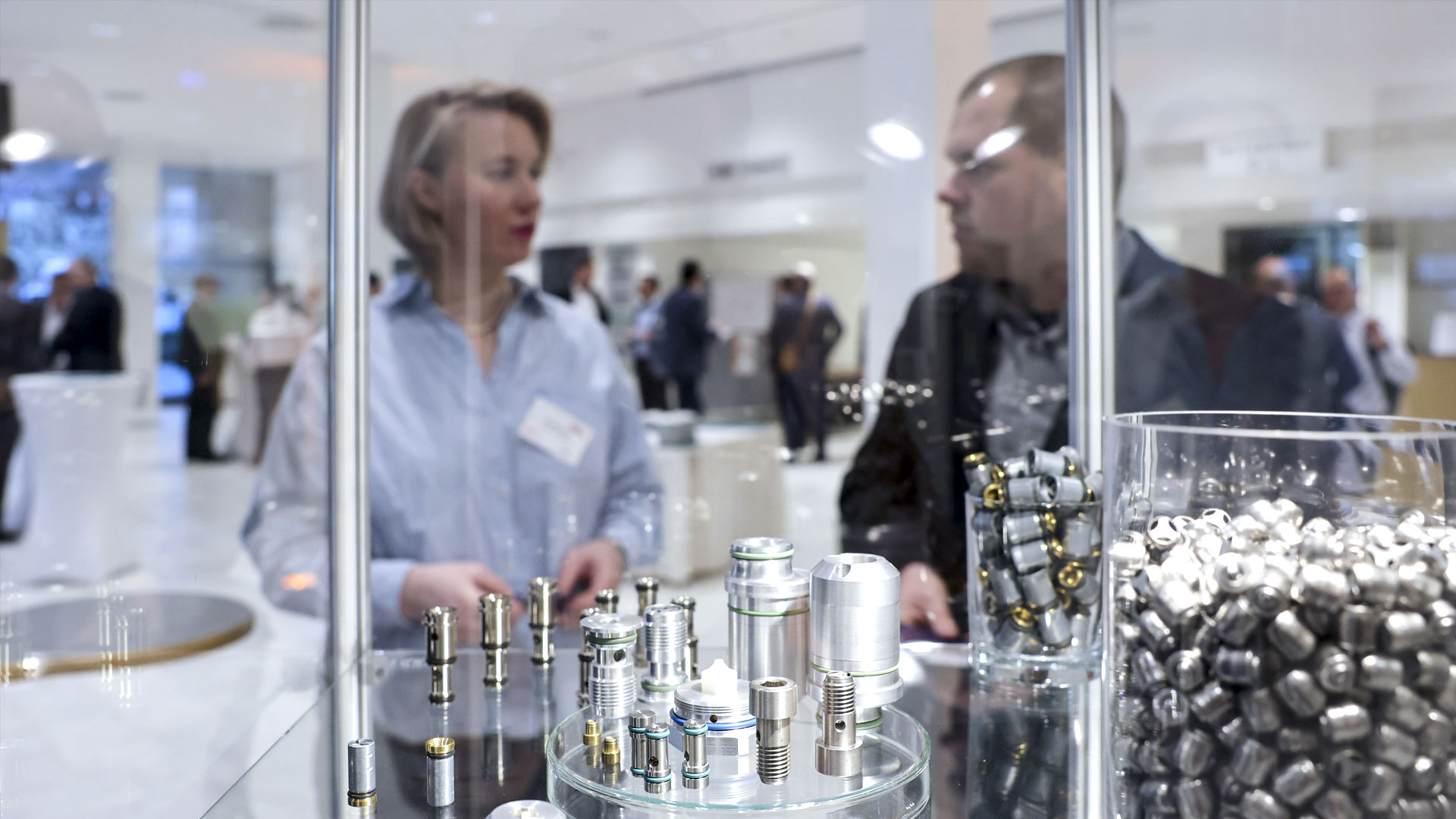 Exhibit in the exhibition area. Two people are chatting in the background.  