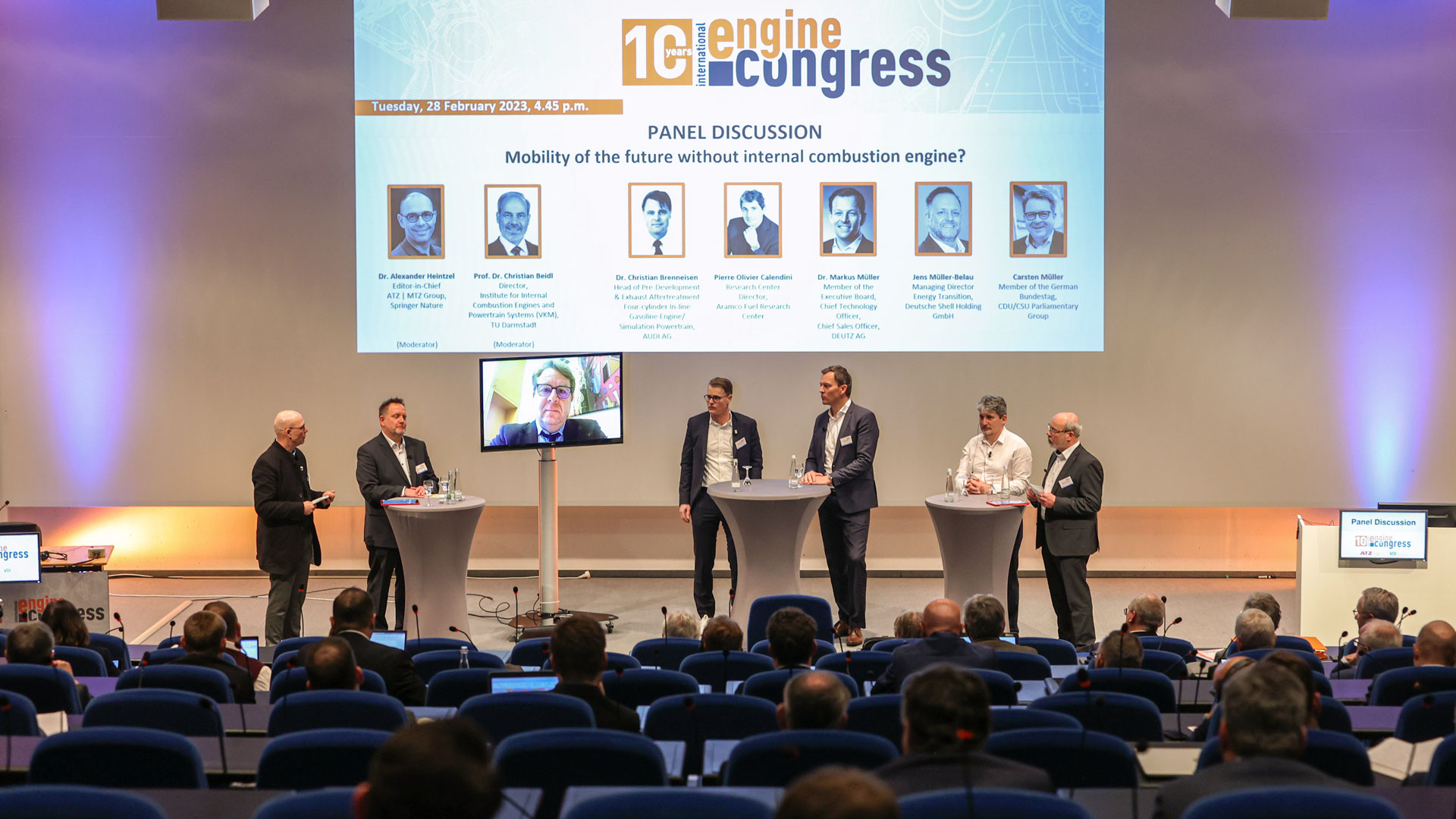 Panel discussion with several conference participants. The audience in the foreground