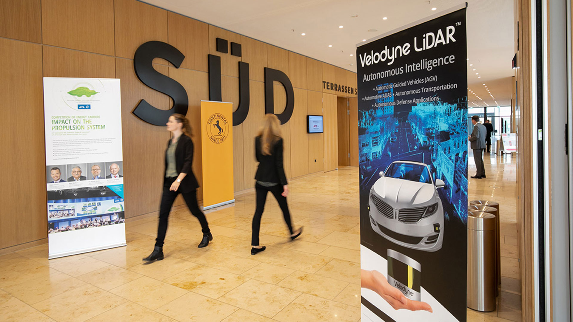 Advertising roll-ups along the walkways inside the conference location